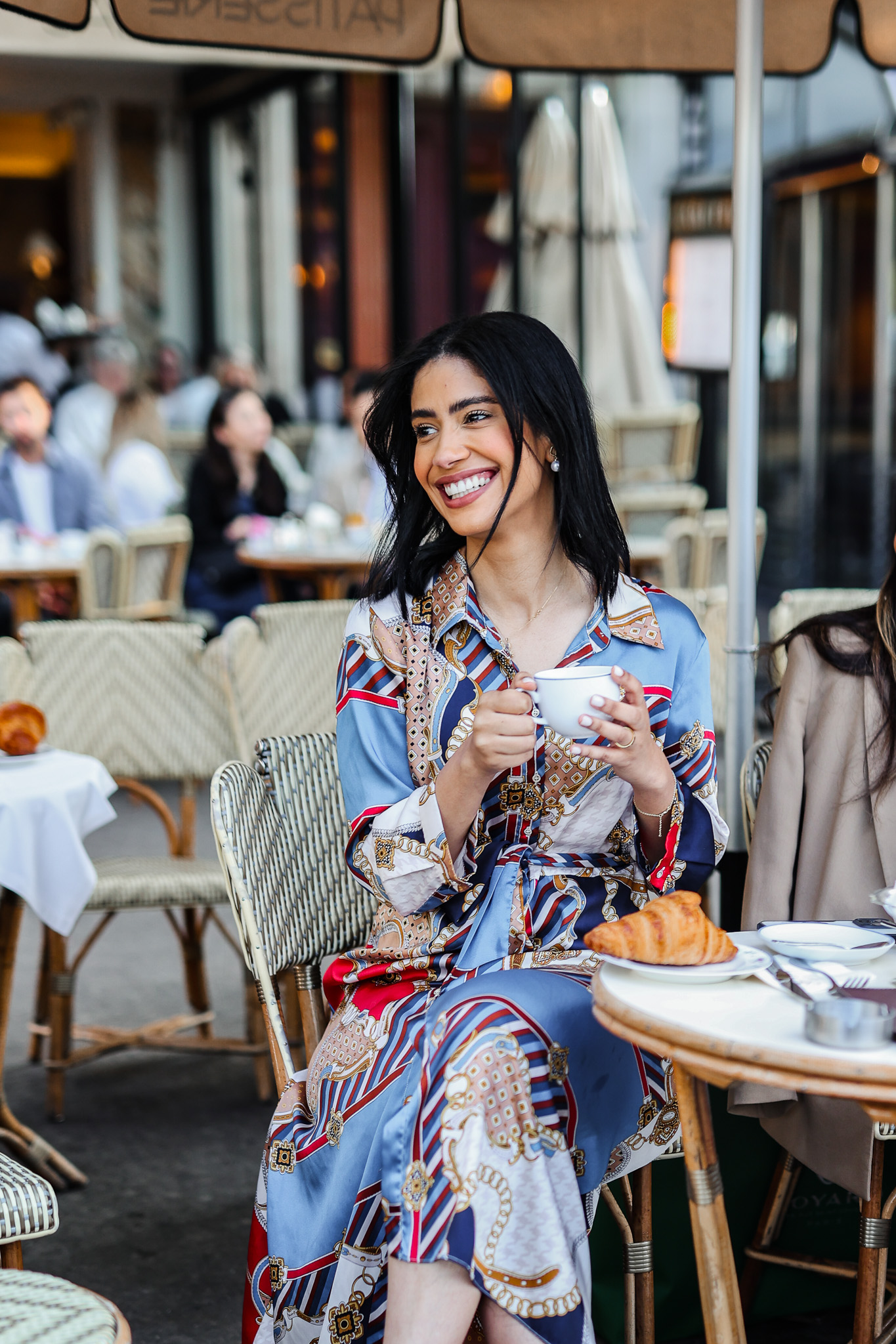 Couple celebrating with confetti near the Eiffel Tower.