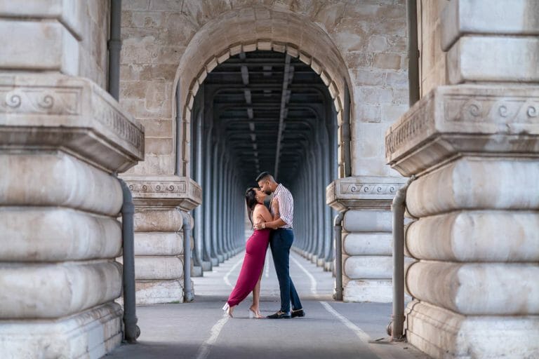 Flowing dress captured in slow motion on a Paris bridge.